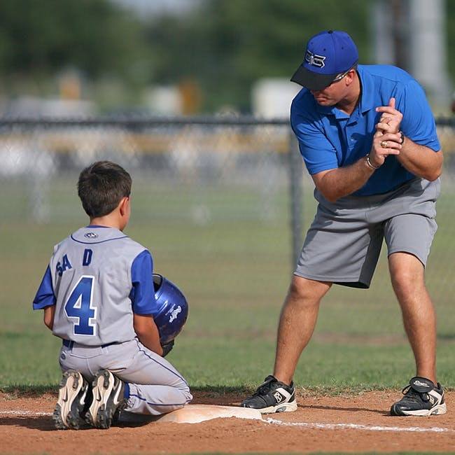 a baseball coach teaching someone